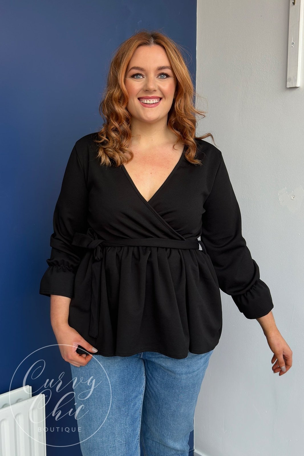 http://curvychiconline.com/cdn/shop/products/black-wrap-plus-size-peplum-top-with-sleeves-283380.jpg?v=1693631884