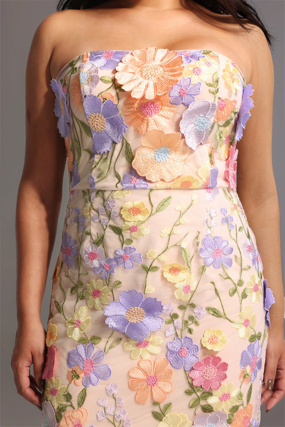 Close up floral embroidery detail on pink dress